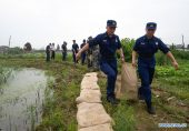 China raises emergency response level as flooding continues