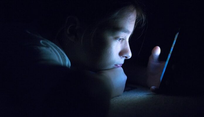teenager blue light phone night