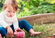 Why Do Growing Children Require Fitted Footwear? toddler trying to wear shoes